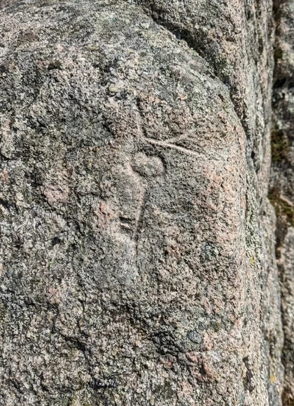 A small key shape on a textured stone.
